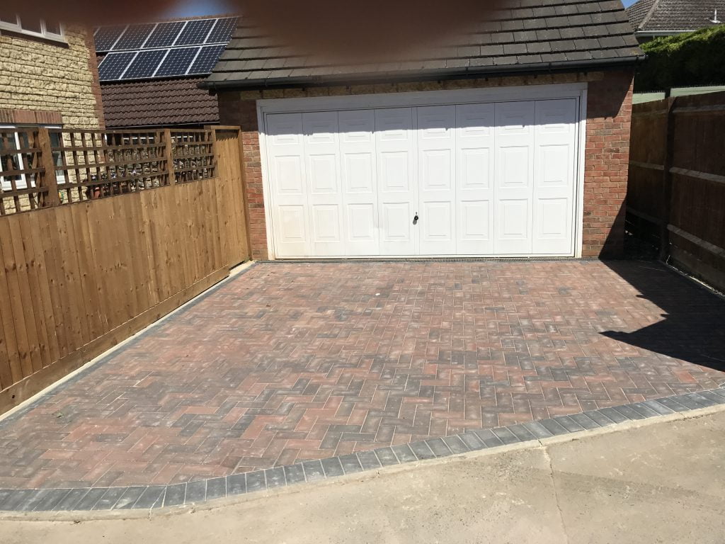 Block paving driveway in front of a garage, laid by Higham Landscapes
