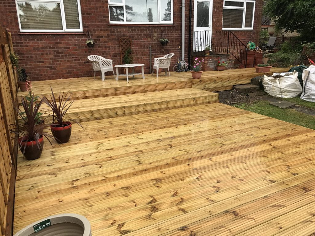 Softwood timber deck with garden furniture, built by Higham Landscapes