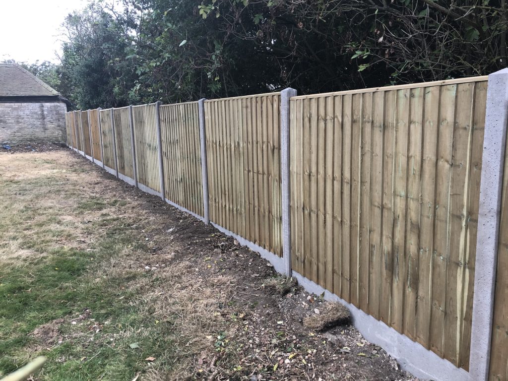 Long run of closeboard fencing with concrete posts installed by Higham Landscapes